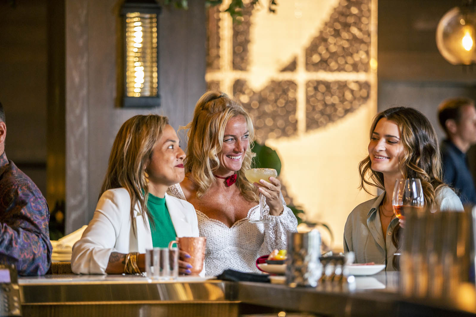 Women enjoying cocktails at the bar at Del Mar Naples restaurant in Florida.
